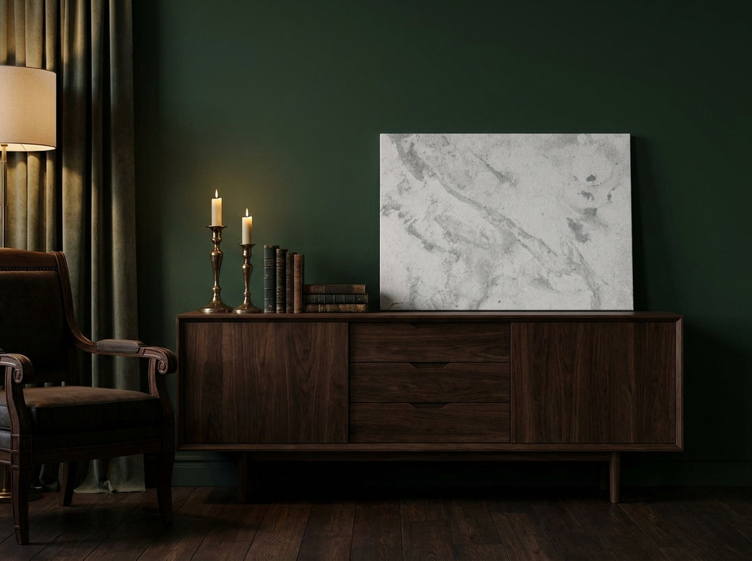 Stretched canvas wall art standing on a sideboard in a moody bedroom
