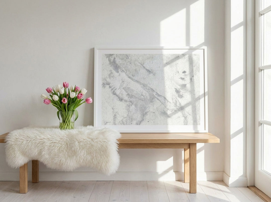 Modern wall art print standing on a bench in a bright Scandinavian home office