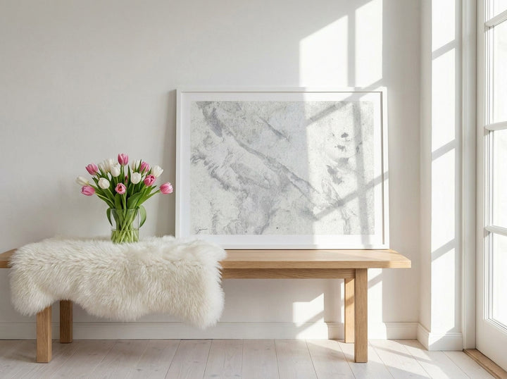 Modern wall art print standing on a bench in a bright Scandinavian home office