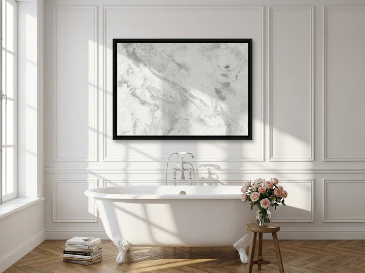 Canvas wall art with a black surround styled on the wall in a Parisian bathroom