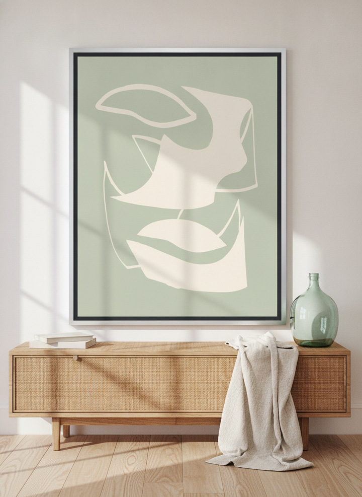 Canvas wall art with a silver leaf surround standing on a sideboard in a coastal home office