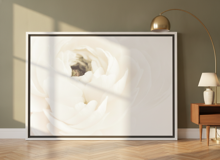 Oversized statement canvas wall art with a white surround leaning against the wall in a mid-century dining room
