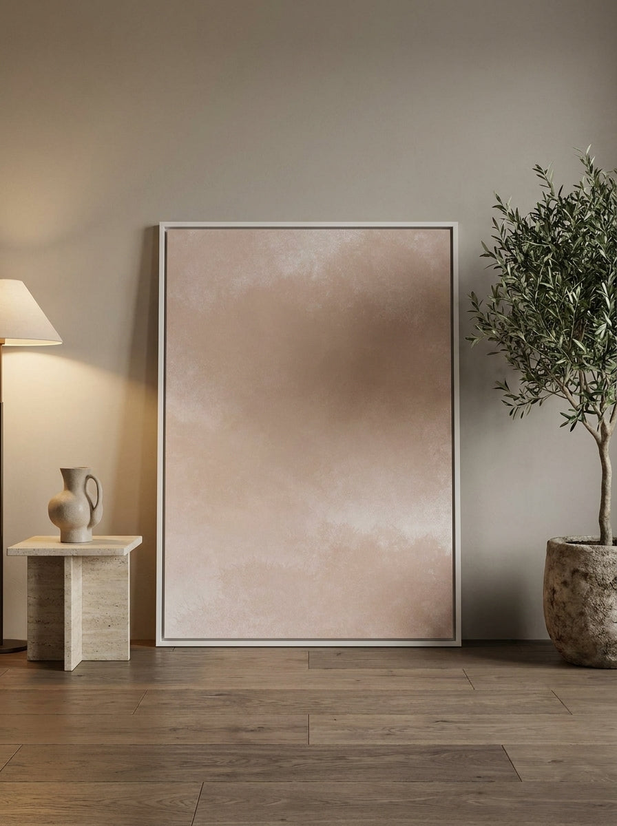 Oversized statement canvas wall art with a white surround leaning against the wall in a luxe bedroom
