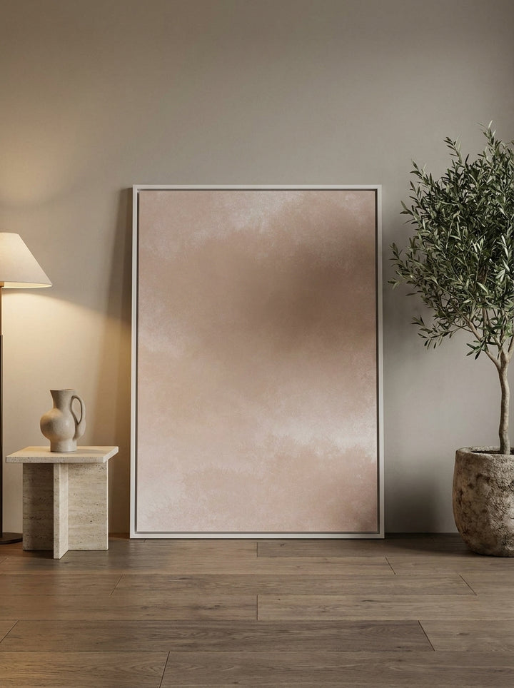 Oversized statement canvas wall art with a white surround leaning against the wall in a luxe bedroom