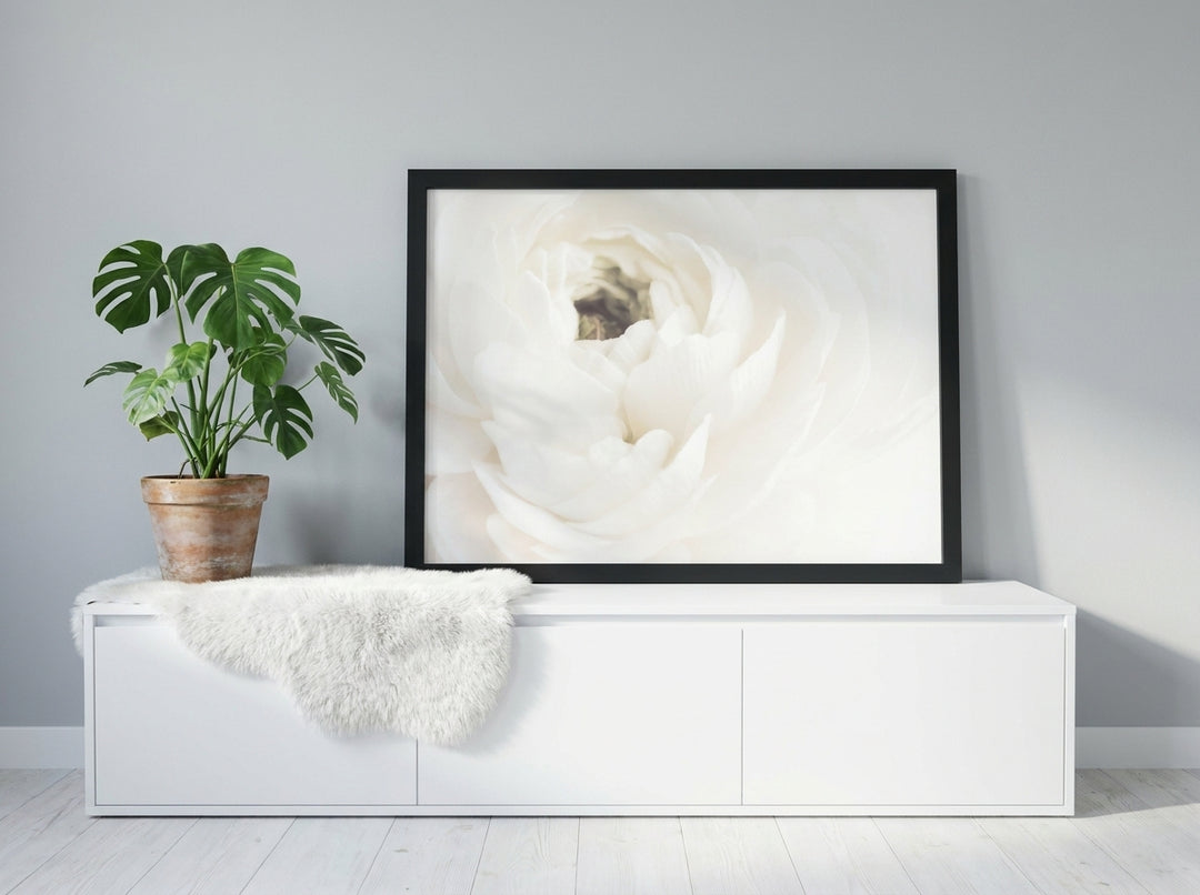 Modern wall art print standing on a sideboard in a bright Scandinavian bathroom