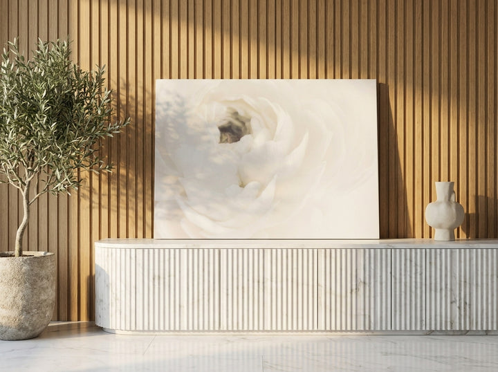 Stretched canvas wall art standing on a sideboard in a luxe bathroom
