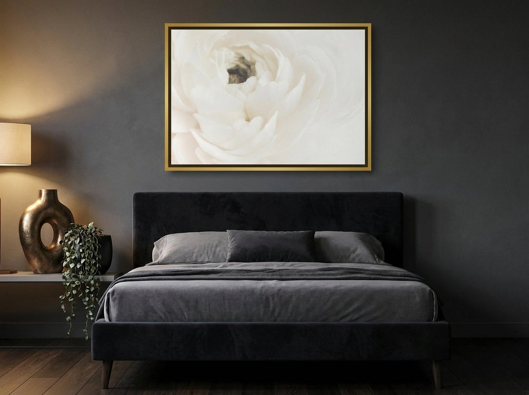Canvas wall art with a gold leaf surround styled on the wall in a moody bedroom