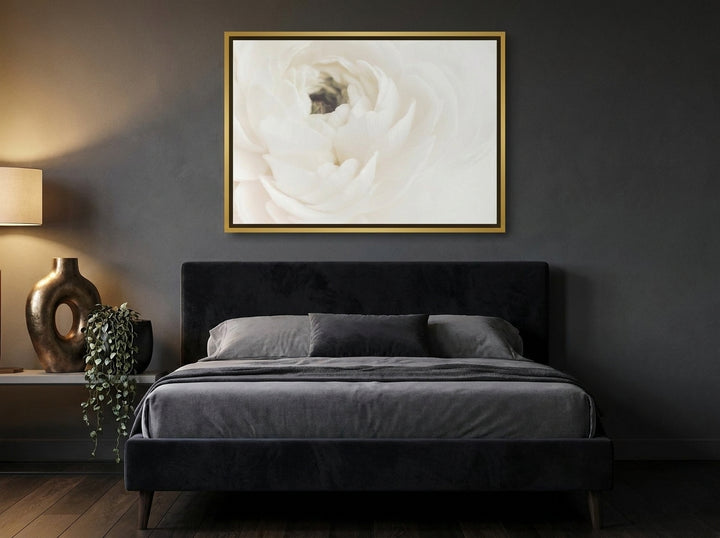 Canvas wall art with a gold leaf surround styled on the wall in a moody bedroom
