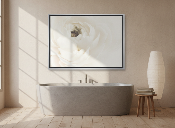 Canvas wall art with a silver leaf surround styled on the wall in a warm Japandi bathroom
