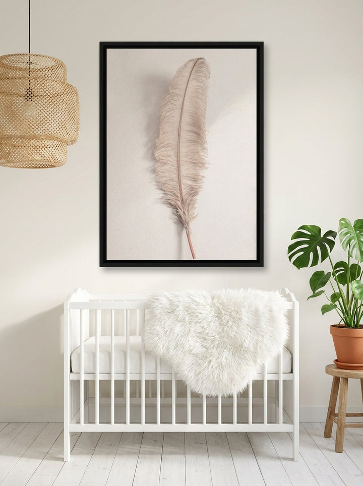 Canvas wall art with a black surround styled on the wall in a bright Scandinavian nursery