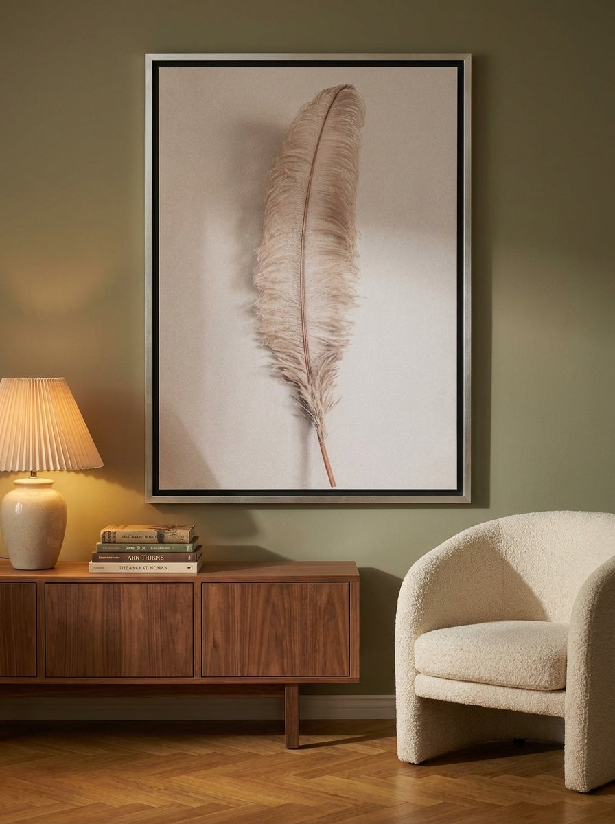 Oversized statement canvas wall art with a silver leaf surround styled on the wall in a mid-century living room