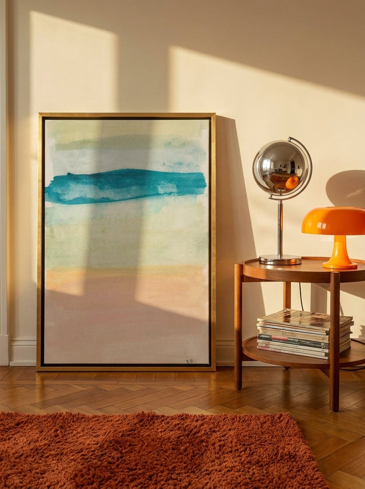 Canvas wall art with a gold leaf surround leaning against the wall in a retro 70s living room