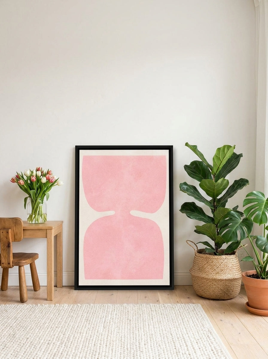 Canvas wall art with a black surround leaning against the wall in a bright Scandinavian nursery