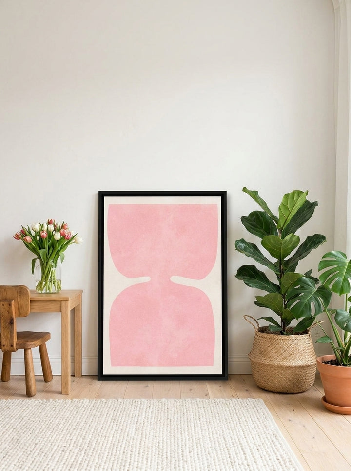 Canvas wall art with a black surround leaning against the wall in a bright Scandinavian nursery