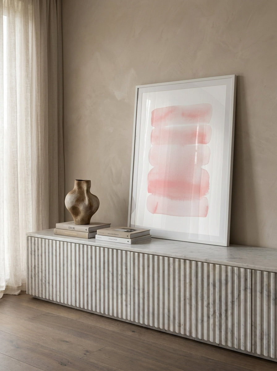 Modern wall art print standing on a sideboard in a luxe bedroom