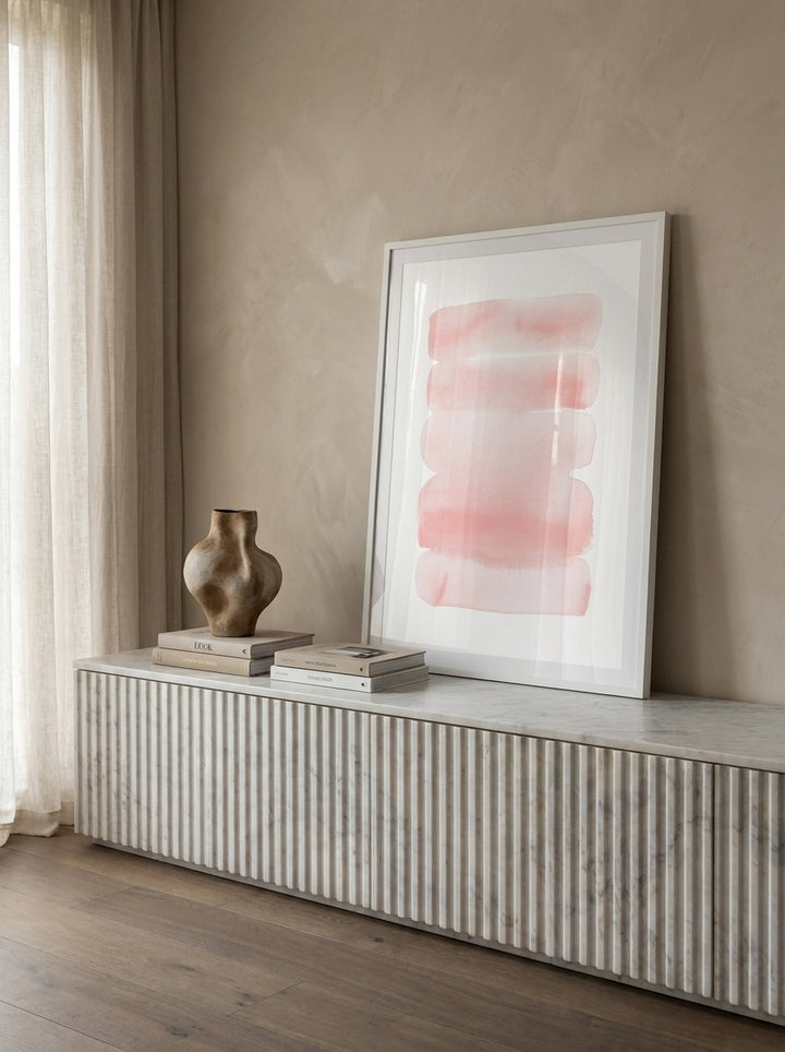 Modern wall art print standing on a sideboard in a luxe bedroom