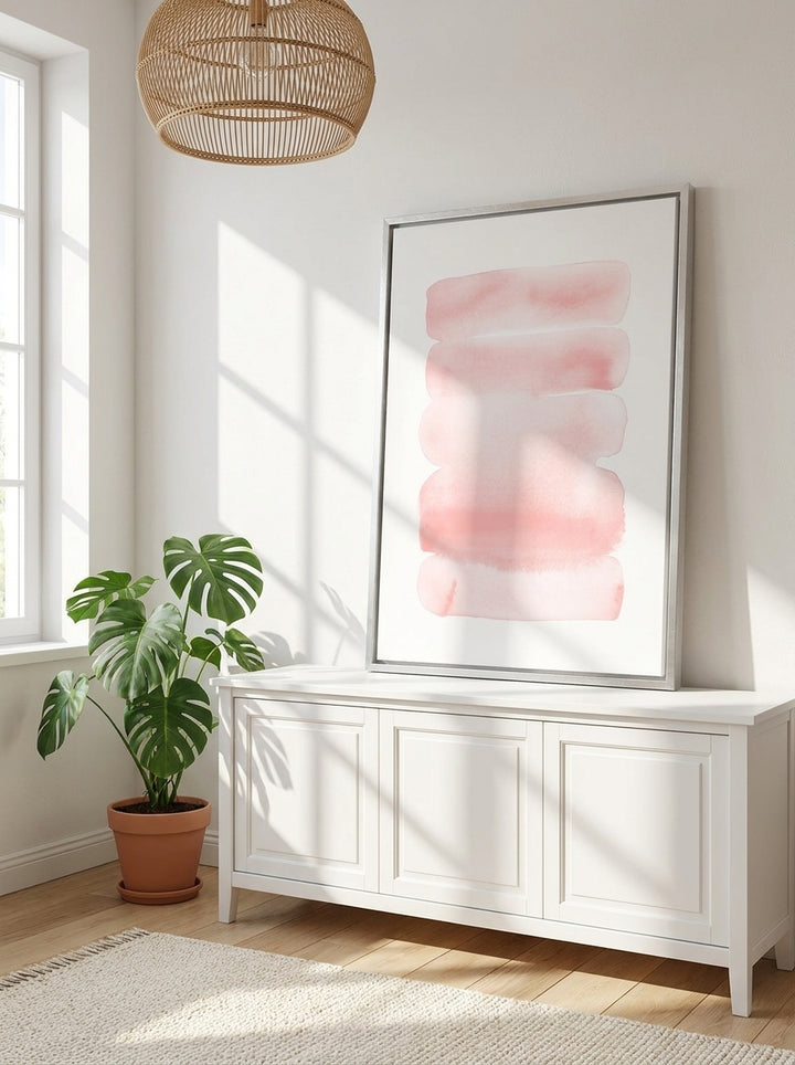 Canvas wall art with a silver leaf surround standing on a sideboard in a bright Scandinavian nursery