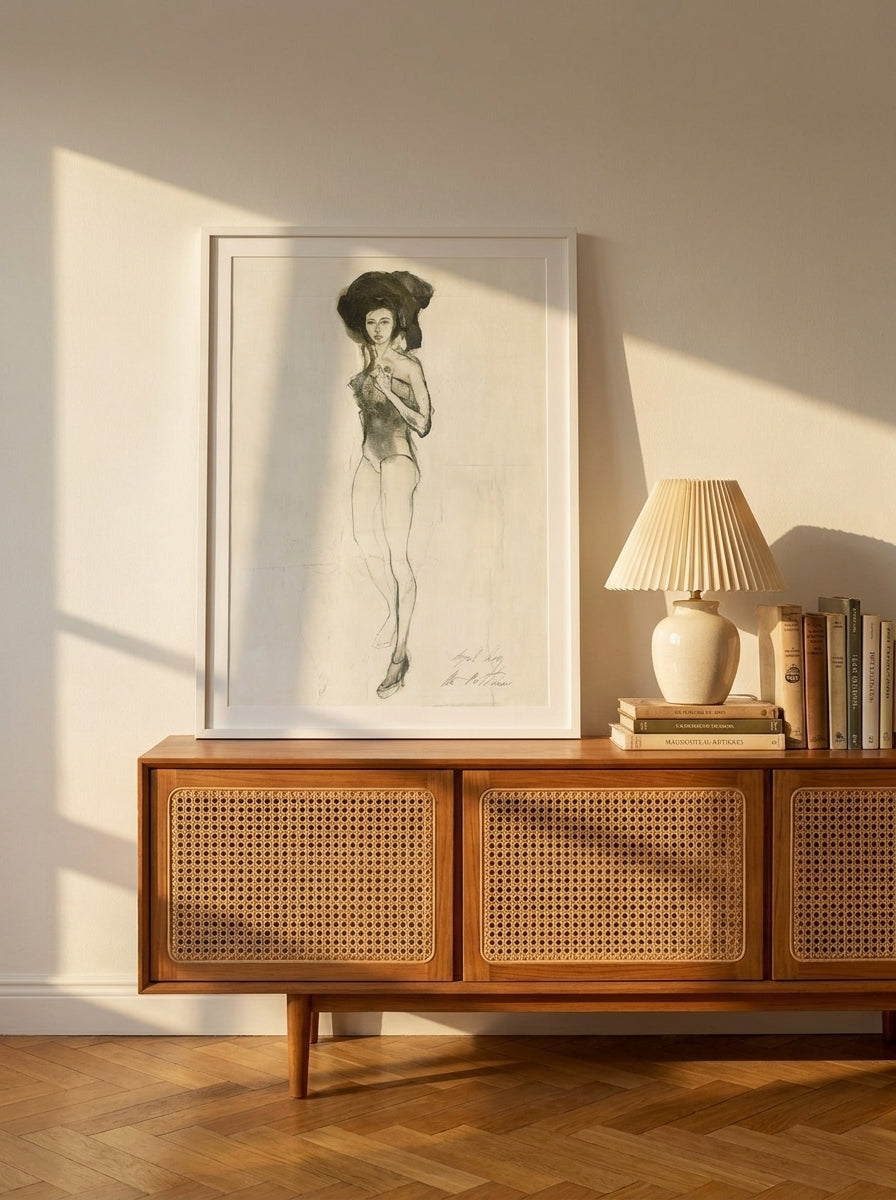 Modern wall art print standing on a sideboard in a mid-century living room