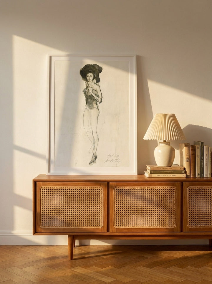 Modern wall art print standing on a sideboard in a mid-century living room