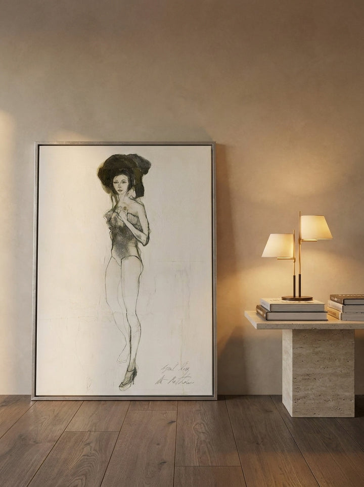Canvas wall art with a silver leaf surround leaning against the wall in a luxe bedroom