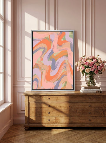 Canvas wall art with a silver leaf surround standing on a sideboard in a Parisian bedroom