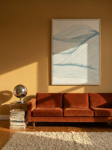 Oversized statement canvas wall art with a white surround styled on the wall in a retro 70s living room
