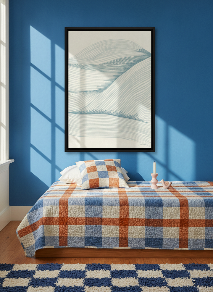 Canvas wall art with a black surround styled on the wall in a colourful eclectic bedroom