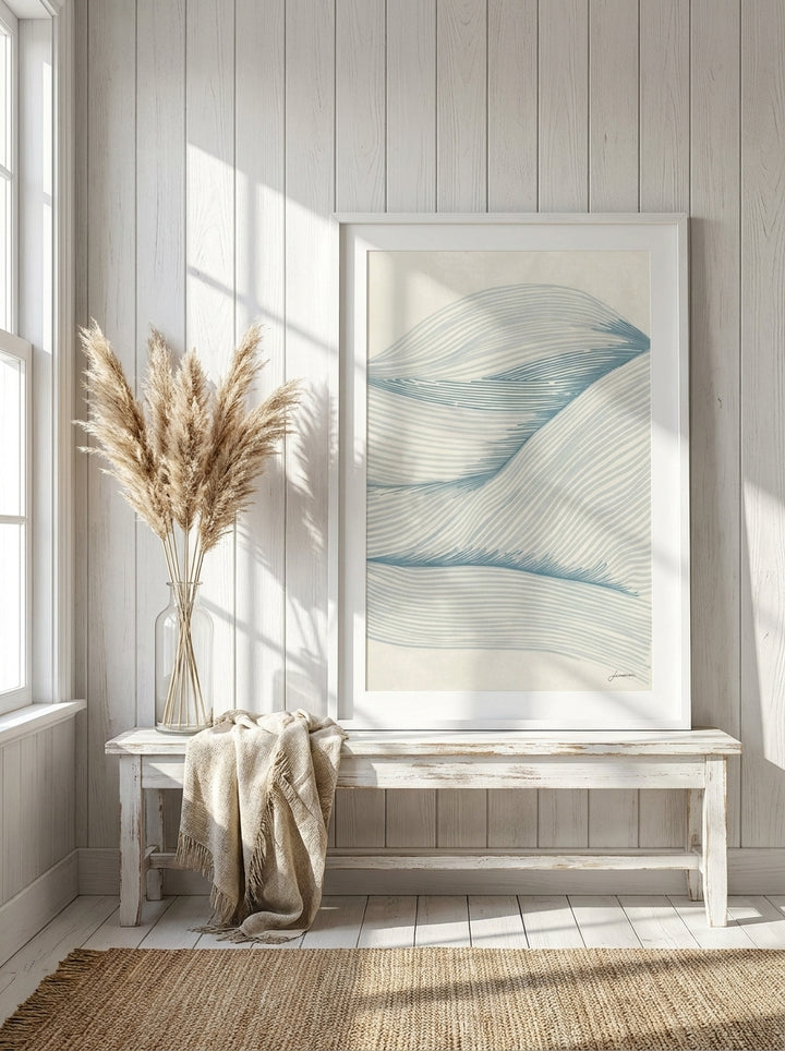 Modern wall art print standing on a console in a coastal home office