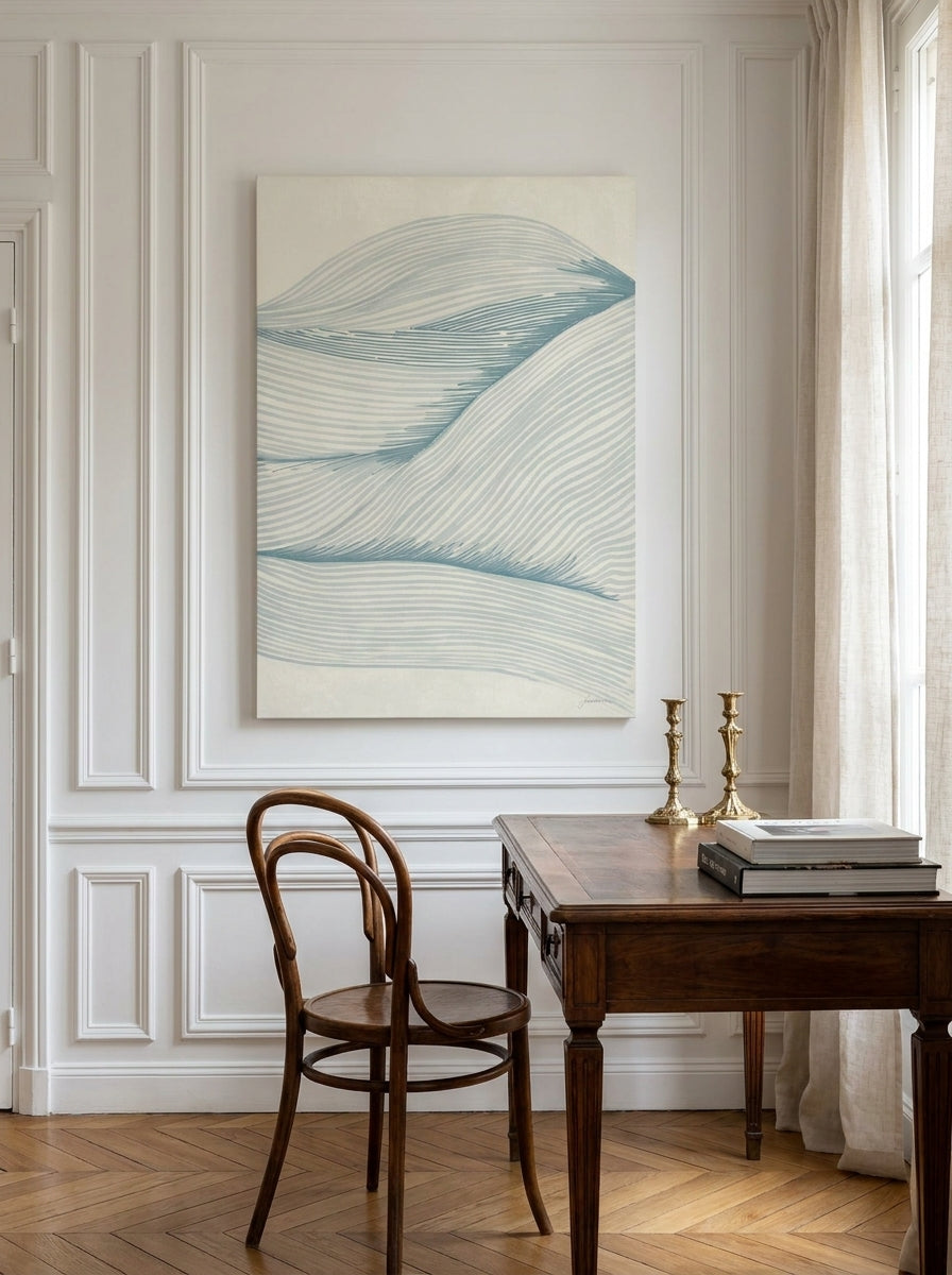 Stretched canvas wall art styled on the wall in a Parisian home office