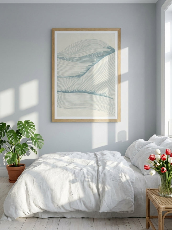 Modern wall art print styled on the wall in a bright Scandinavian bedroom