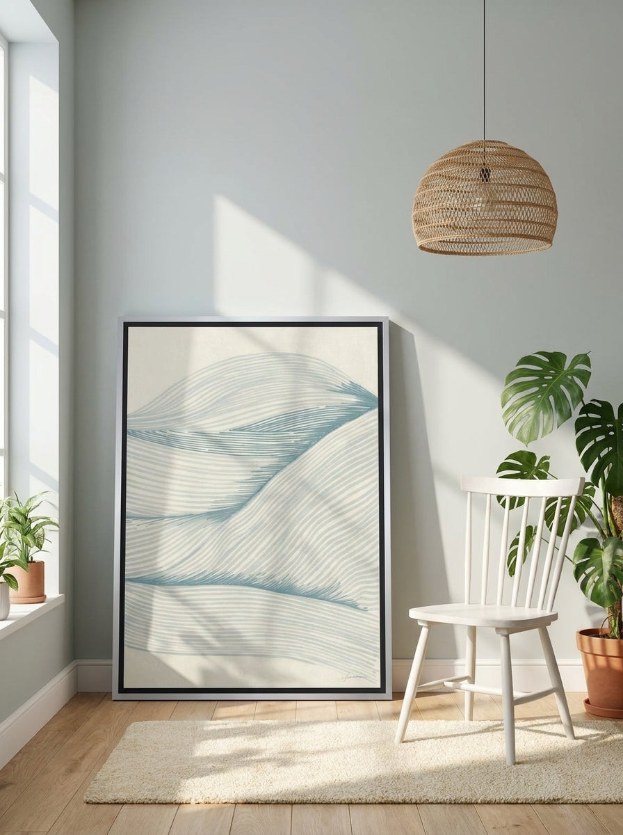 Canvas wall art with a silver leaf surround leaning against the wall in a bright Scandinavian bathroom