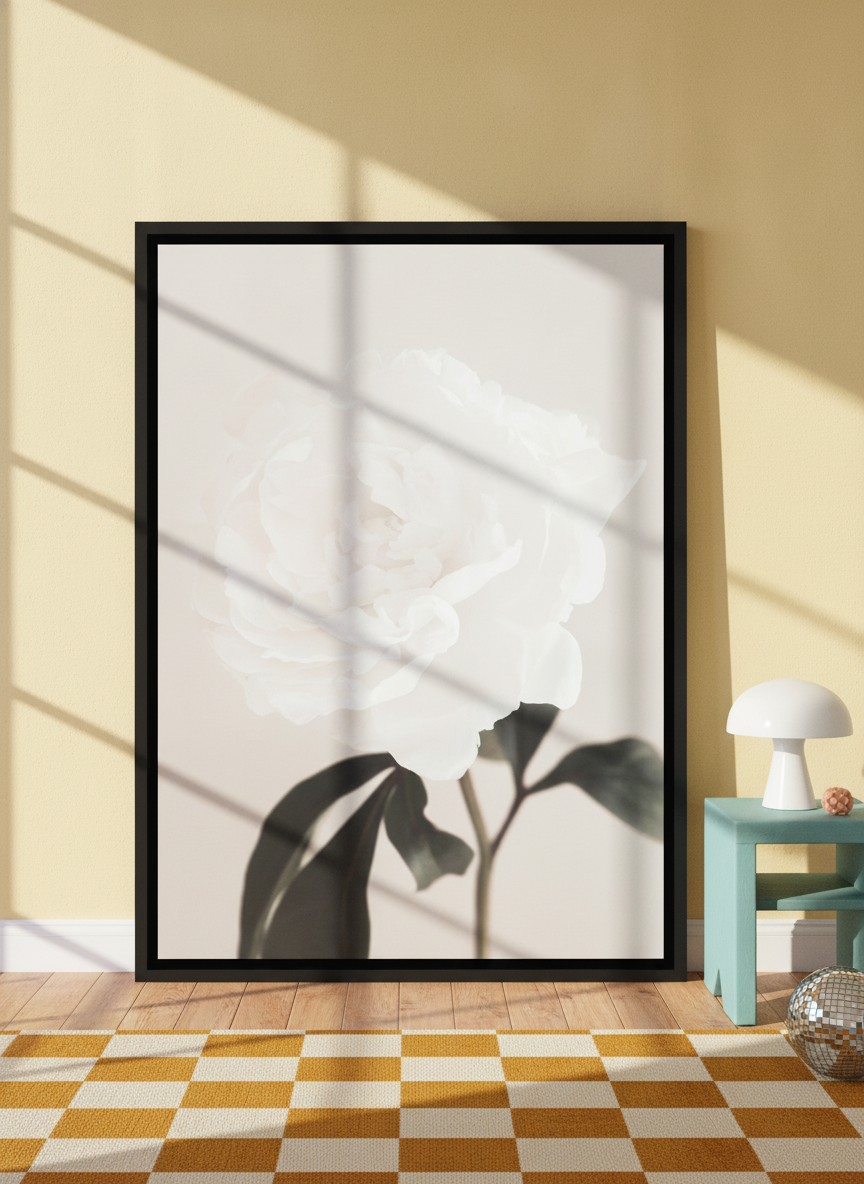 Oversized statement canvas wall art with a black surround leaning against the wall in a colourful eclectic living room