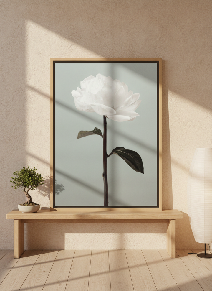 Canvas wall art with a natural timber surround standing on a bench in a warm Japandi bathroom
