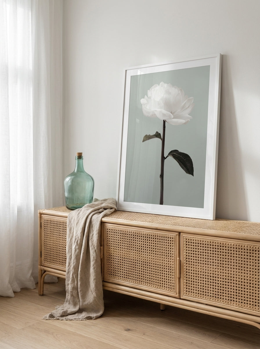 Modern wall art print standing on a sideboard in a coastal bathroom