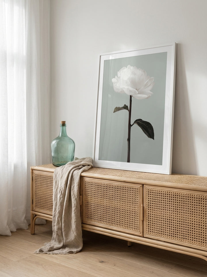 Modern wall art print standing on a sideboard in a coastal bathroom