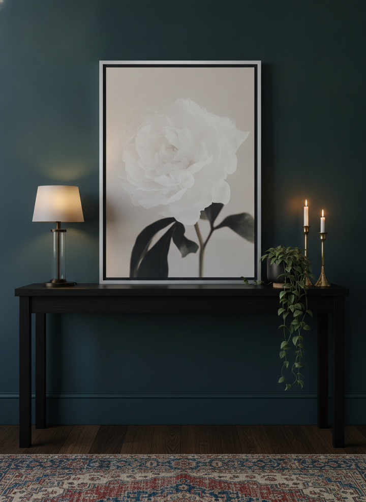 Canvas wall art with a silver leaf surround standing on a console in a moody home office