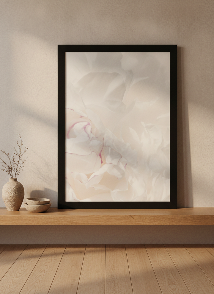Modern wall art print standing on a shelf in a warm Japandi bathroom