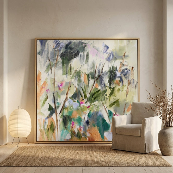Oversized statement canvas wall art with a natural timber surround leaning against the wall in a warm Japandi dining room