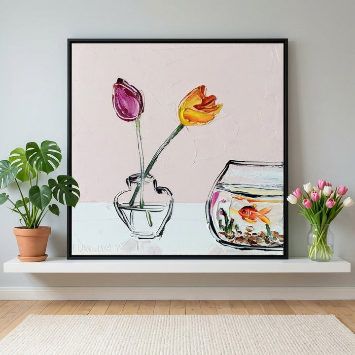 Canvas wall art with a black surround standing on a shelf in a bright Scandinavian living room