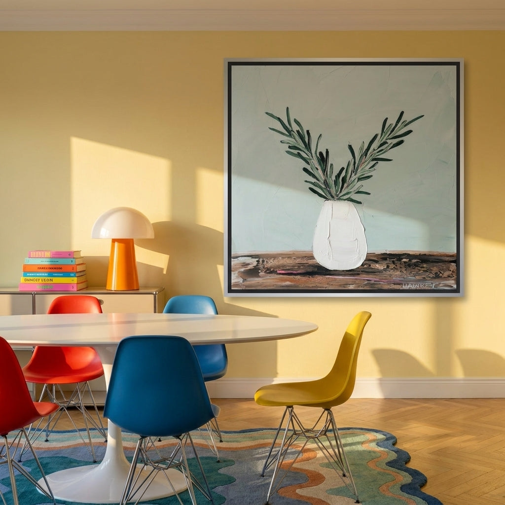 Canvas wall art with a silver leaf surround styled on the wall in a colourful eclectic dining room