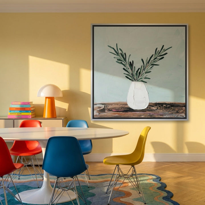 Canvas wall art with a silver leaf surround styled on the wall in a colourful eclectic dining room