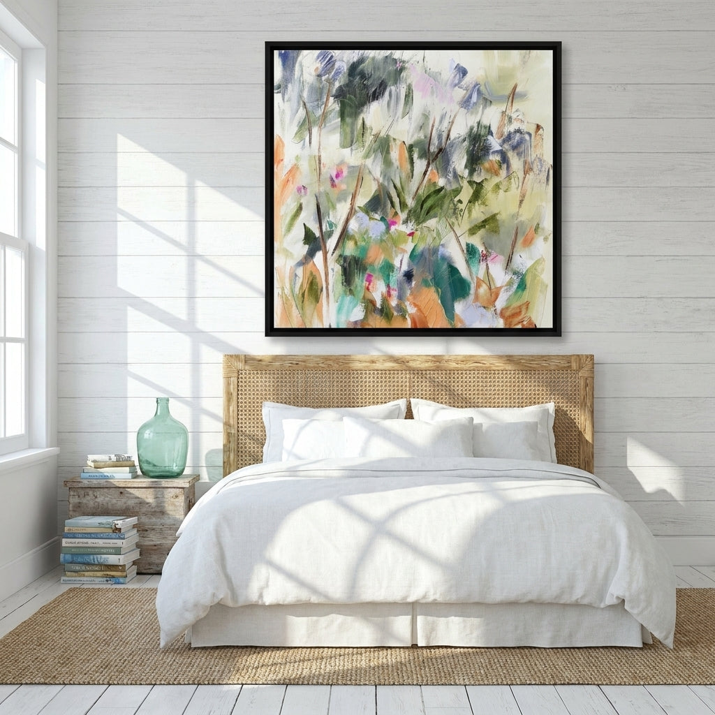Canvas wall art with a black surround styled on the wall in a coastal bedroom