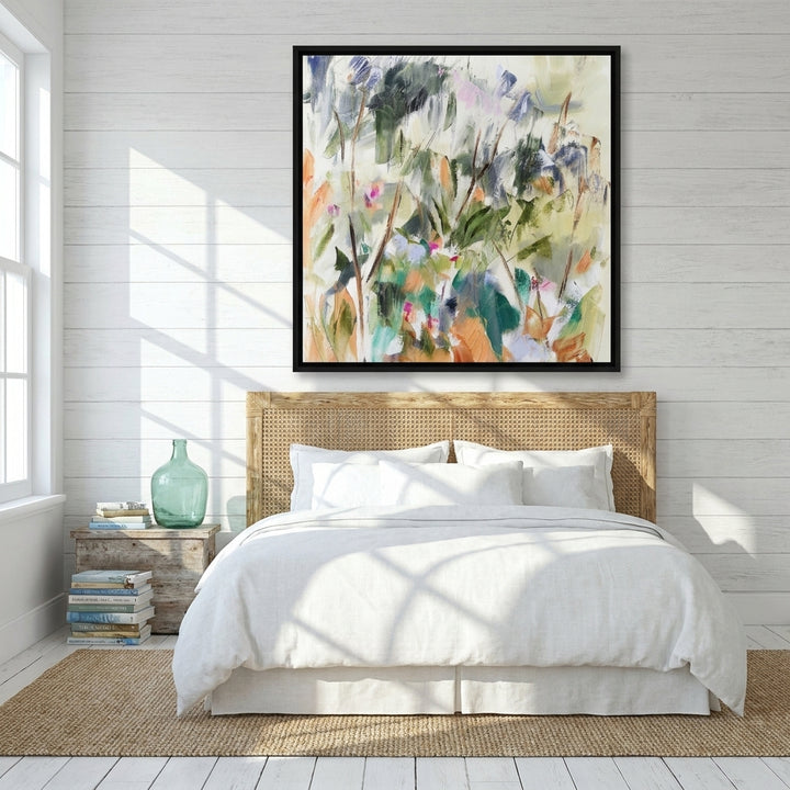 Canvas wall art with a black surround styled on the wall in a coastal bedroom