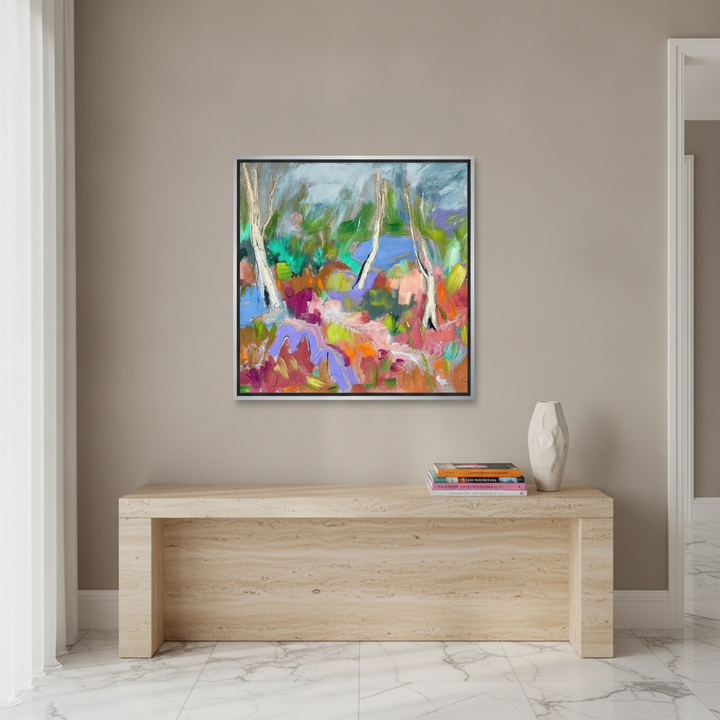 Canvas wall art with a silver leaf surround styled on the wall in a luxe living room
