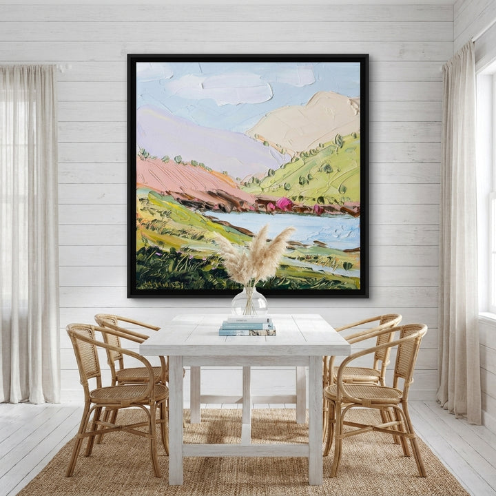 Oversized statement canvas wall art with a black surround styled on the wall in a coastal dining room