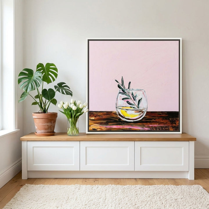 Canvas wall art with a white surround standing on a kitchen bench in a bright Scandinavian kitchen