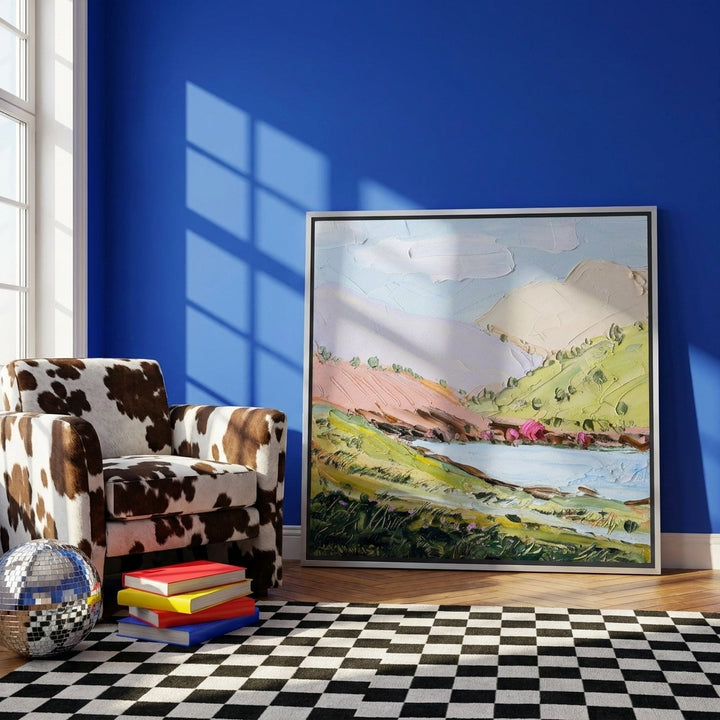 Canvas wall art with a silver leaf surround leaning against the wall in a colourful eclectic bedroom
