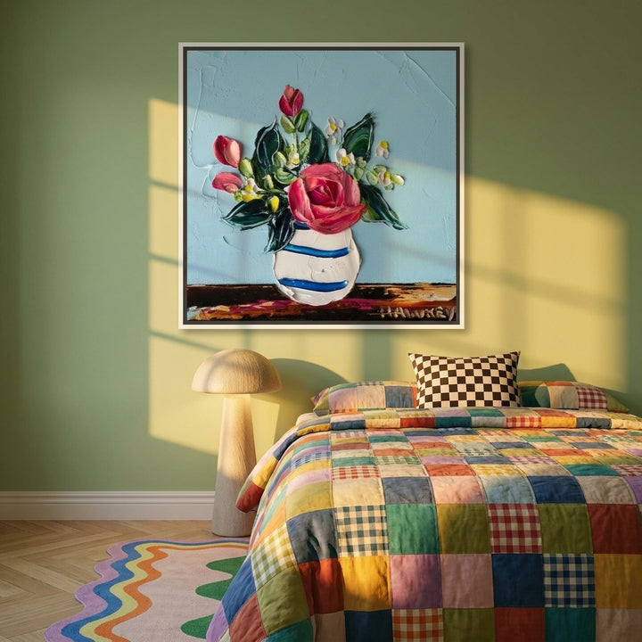 Canvas wall art with a white surround styled on the wall in a colourful eclectic bedroom