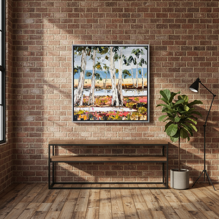 Canvas wall art with a silver leaf surround styled on the wall in an industrial loft living room