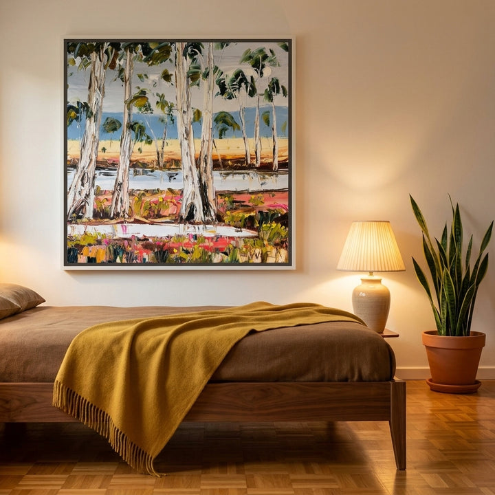 Canvas wall art with a white surround styled on the wall in a mid-century bedroom